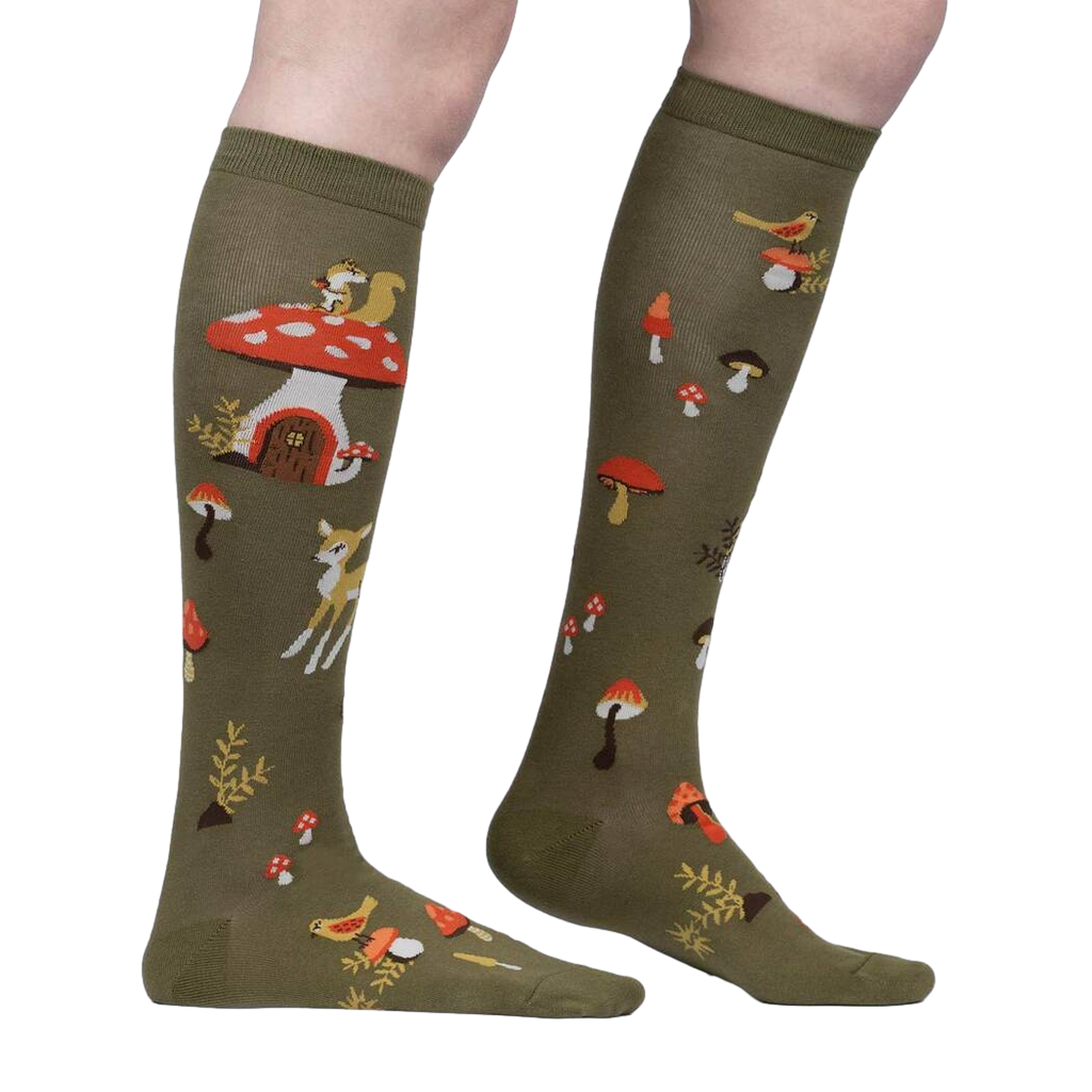 Close-up side view of the socks highlighting the details of the whimsical mushroom houses and woodland creatures.