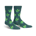 Pair of crew socks in dark teal with a pattern of cartoon marijuana leaves wearing sunglasses and giving peace signs.