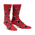 Pair of red crew socks with an all-over print of pugs wearing bow ties.  The pugs are light brown and the background is a coral red.