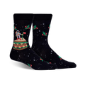 Pair of black crew socks with an astronaut on a sandwich in space, surrounded by orbiting pickles.  Red, green, and white details against a dark background.
