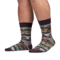 Lifestyle shot of a person's legs wearing Cabin Life socks, showcasing the full sock design on the feet.
