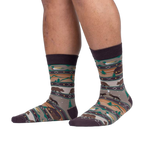 Lifestyle shot of a person's legs wearing Cabin Life socks, showcasing the full sock design on the feet.