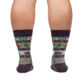 Rear view of a person wearing Cabin Life socks, showing the design on the back of the socks.