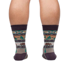 Rear view of a person wearing Cabin Life socks, showing the design on the back of the socks.