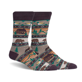 pair of socks featuring a cabin, bears, trees, and ducks in a woodland pattern. the socks are a brown, beige, green, and orange color. the socks are photographed from an angle with the right sock over the left sock.