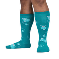 Lifestyle shot showing teal sheep socks on a person's legs.