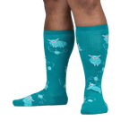 Lifestyle shot showing teal sheep socks on a person's legs.