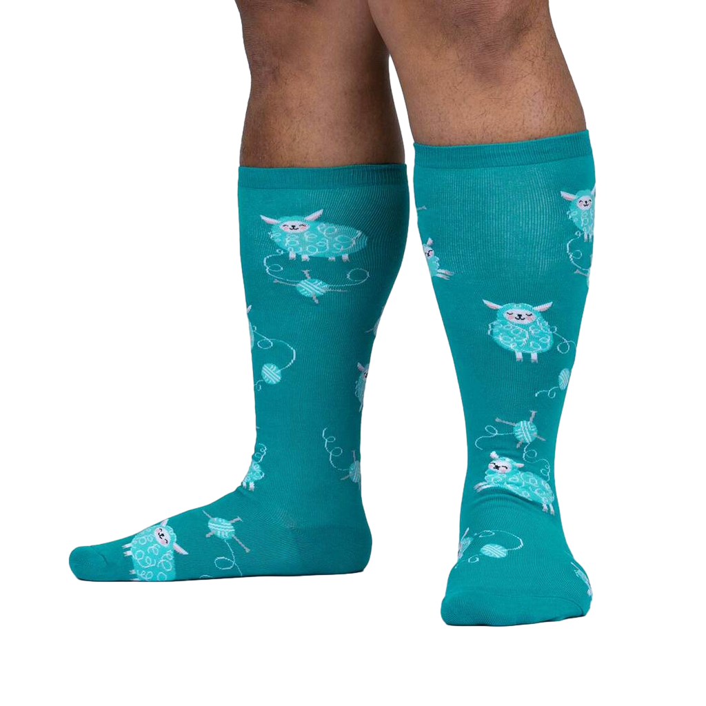 Lifestyle shot showing teal sheep socks on a person's legs.