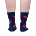 Flatlay image of a pair of red crew socks with maroon fuzzy hearts.