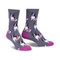 Gray crew socks with a repeating pattern of black and white French Bulldogs carrying pink treats.  The socks have a fuchsia-colored heel and toe.