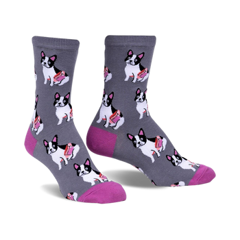 Gray crew socks with a repeating pattern of black and white French Bulldogs carrying pink treats.  The socks have a fuchsia-colored heel and toe.