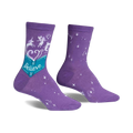 Purple crew socks with a whimsical design. Features a teal book with 'Believe', unicorns, fairies, and white stars.