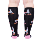 Rear view of the socks on a person's legs, highlighting the full pattern.
