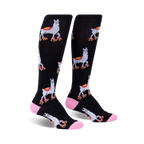 Pair of black knee-high socks with a repeating pattern of llamas wearing roller skates.  Accented with pink at the cuffs.