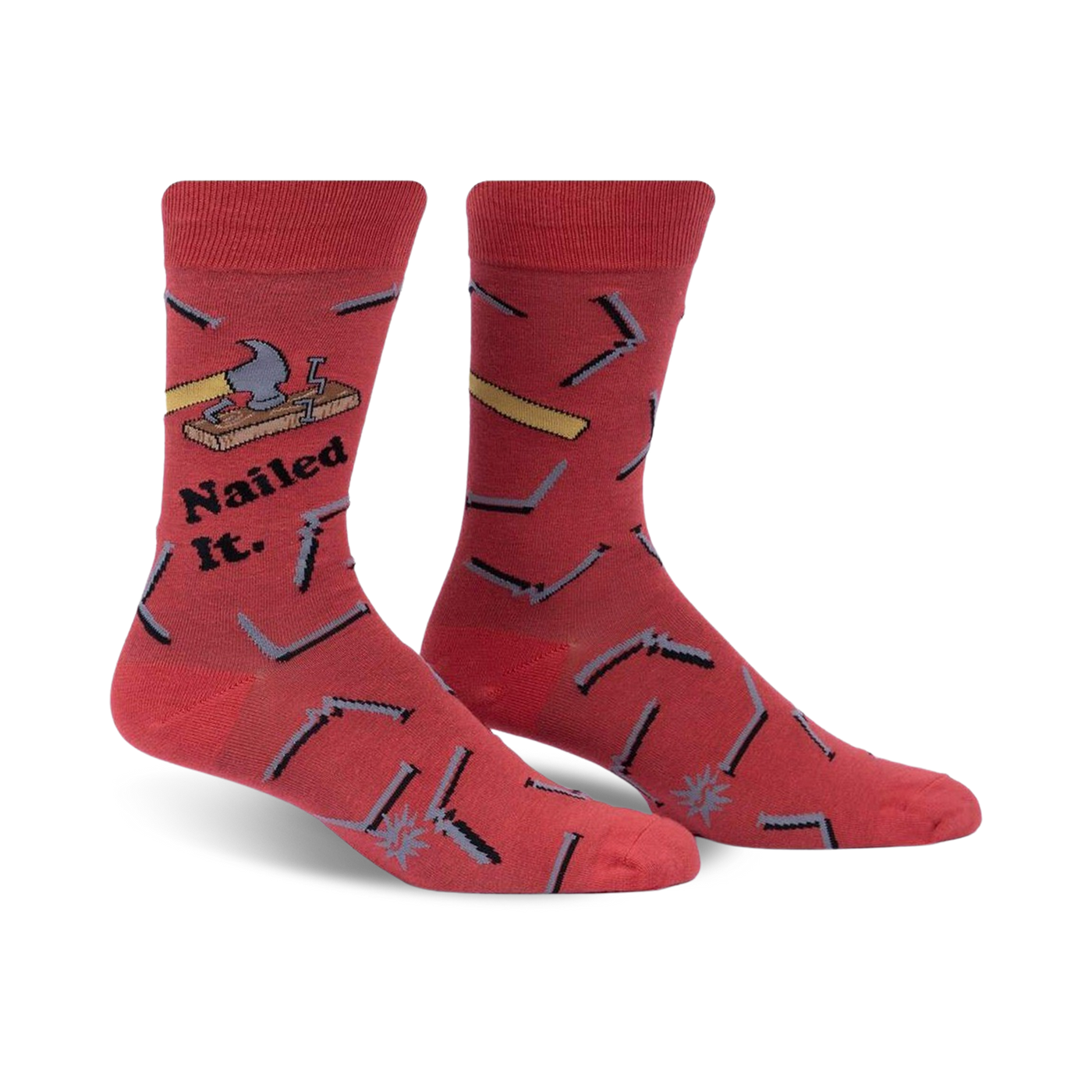 Pair of red crew socks featuring a hammer, nails, and the phrase 'Nailed It.'  Fun, quirky design.