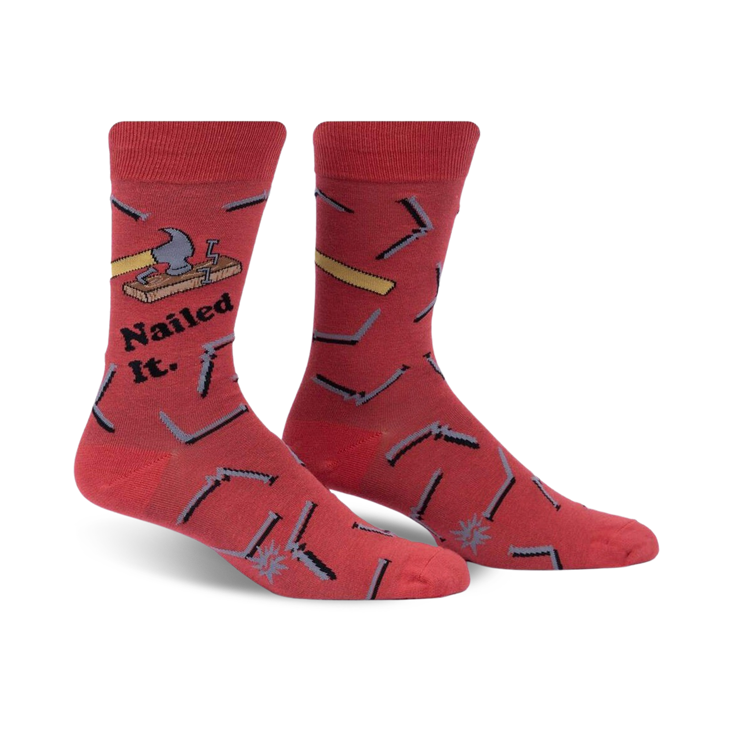 Pair of red crew socks featuring a hammer, nails, and the phrase 'Nailed It.'  Fun, quirky design.