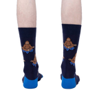 Back view of the Meditating Bigfoot socks worn on a person's legs. Shows the full design on each sock.