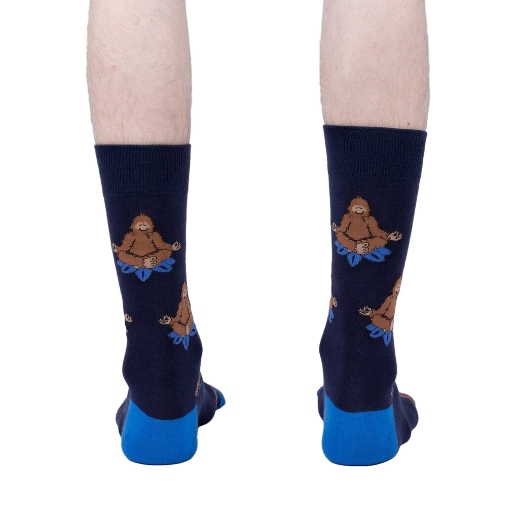 Back view of the Meditating Bigfoot socks worn on a person's legs. Shows the full design on each sock.