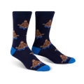 Pair of navy blue crew socks with a repeating pattern of brown Bigfoot figures meditating on blue lotus flowers.  Features a royal blue cuff.
