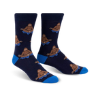 Pair of navy blue crew socks with a repeating pattern of brown Bigfoot figures meditating on blue lotus flowers.  Features a royal blue cuff.