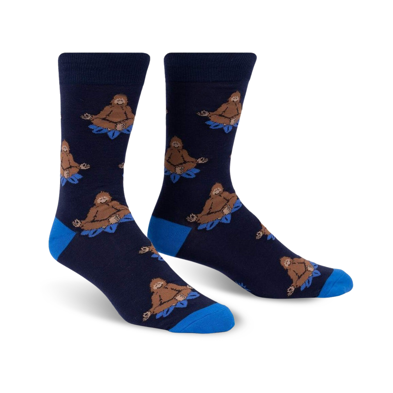Pair of navy blue crew socks with a repeating pattern of brown Bigfoot figures meditating on blue lotus flowers.  Features a royal blue cuff.