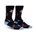 Pair of black crew socks with light blue cuffs. Features a whimsical design of medical icons like stethoscopes, bandages, and syringes.