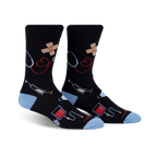 Pair of black crew socks with light blue cuffs. Features a whimsical design of medical icons like stethoscopes, bandages, and syringes.