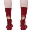 Rear view of a person wearing the Yule Log socks, showcasing the full design on the back of the socks.