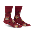 Pair of burgundy crew socks with a repeating pattern of burning yule logs in a fireplace. 