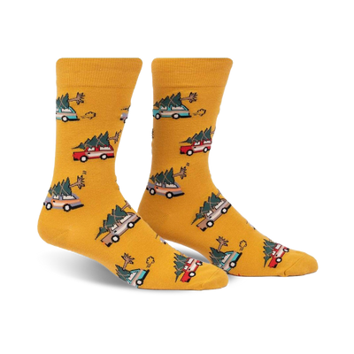 yellow crew socks with festive pattern of green, red, and blue christmas trees and brown cars carrying them. for men.   