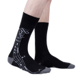 Lifestyle shot: A model wearing the black 'Music Is My Forte' socks, showcasing the design and fit.