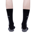 Rear view of the socks on a model, showing the full musical notation print.