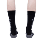 Rear view of the socks on a model, showing the full musical notation print.