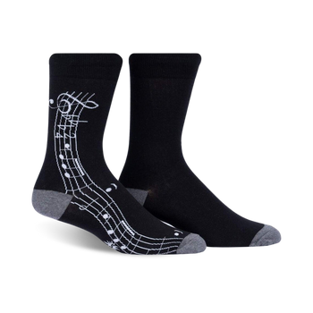 black mens crew socks with a pattern of white treble clefs and music notes.   
