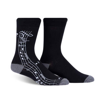 black mens crew socks with a pattern of white treble clefs and music notes.   