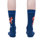 Rear view of a person wearing a pair of navy blue 'Zero Fox Given' socks. The fox graphic and text are partially visible on each sock.