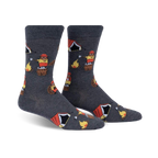 Pair of crew socks in dark gray featuring beavers roasting marshmallows around a campfire with small orange tents. Fun and whimsical design.
