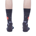 Rear view of 'Lets Kick It' socks worn on a person's feet showing the complete back of the sock design.