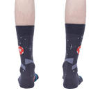 Rear view of 'Lets Kick It' socks worn on a person's feet showing the complete back of the sock design.