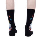 Rear view of the socks on a person's legs, highlighting the design on the back of the socks.