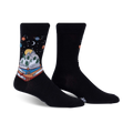 Pair of black crew socks featuring a whimsical design of a book with a mountain landscape inside, set against a starry night sky with planets.