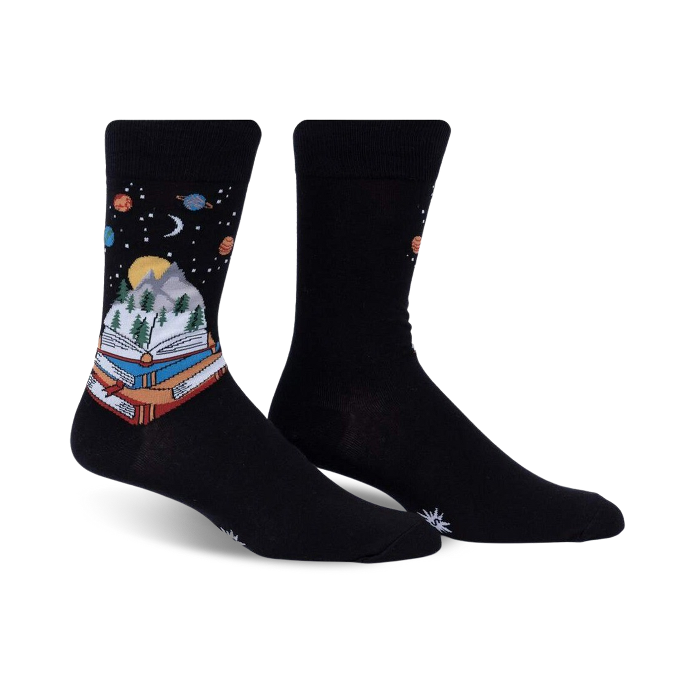 Pair of black crew socks featuring a whimsical design of a book with a mountain landscape inside, set against a starry night sky with planets.