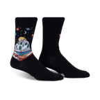 Pair of black crew socks featuring a whimsical design of a book with a mountain landscape inside, set against a starry night sky with planets.