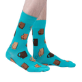 A lifestyle shot showing the teal 'Kiss My' socks on a person's feet.