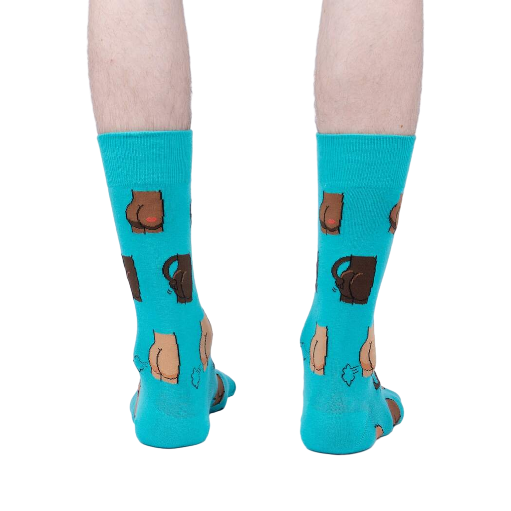 Back view of a pair of teal 'Kiss My' socks on a person's legs.