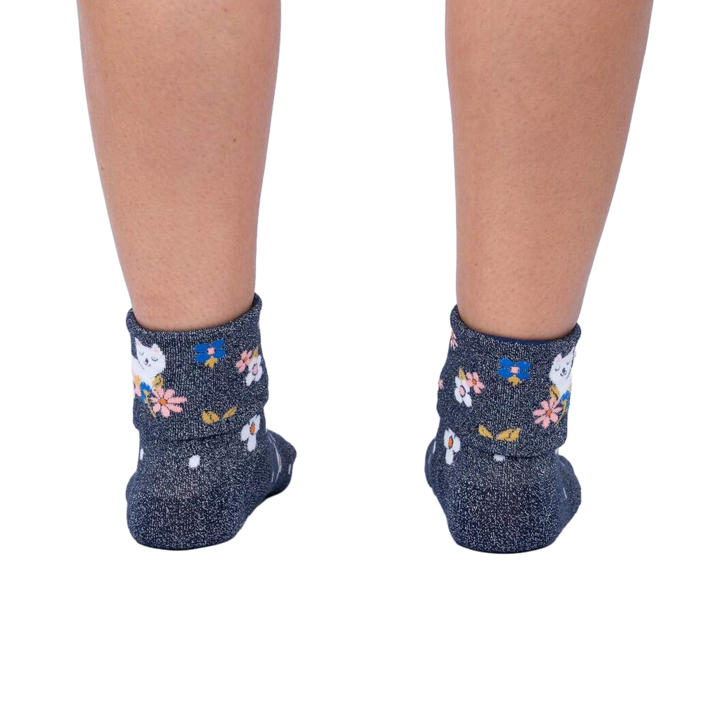 Rear view of a person's legs wearing the Sitting Kitty Turn Cuff socks, showcasing the rolled-down cuff design.