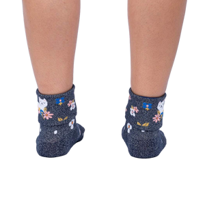 Rear view of a person's legs wearing the Sitting Kitty Turn Cuff socks, showcasing the rolled-down cuff design.