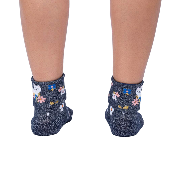 Rear view of a person's legs wearing the Sitting Kitty Turn Cuff socks, showcasing the rolled-down cuff design.