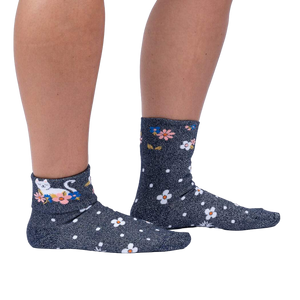 Lifestyle shot of a person wearing the Sitting Kitty Turn Cuff socks, standing against a white background.