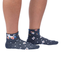 Another lifestyle shot of a person wearing the Sitting Kitty Turn Cuff socks, standing against a white background, from a slightly different angle.